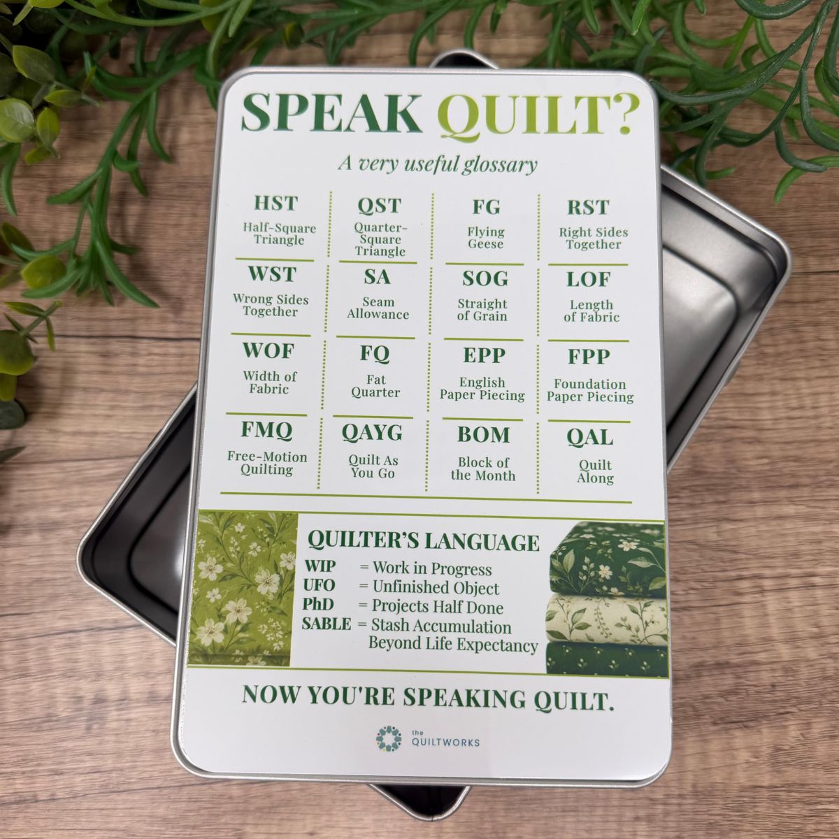 Speak Quilt sewing storage tin featuring common quilting abbreviations and terminology